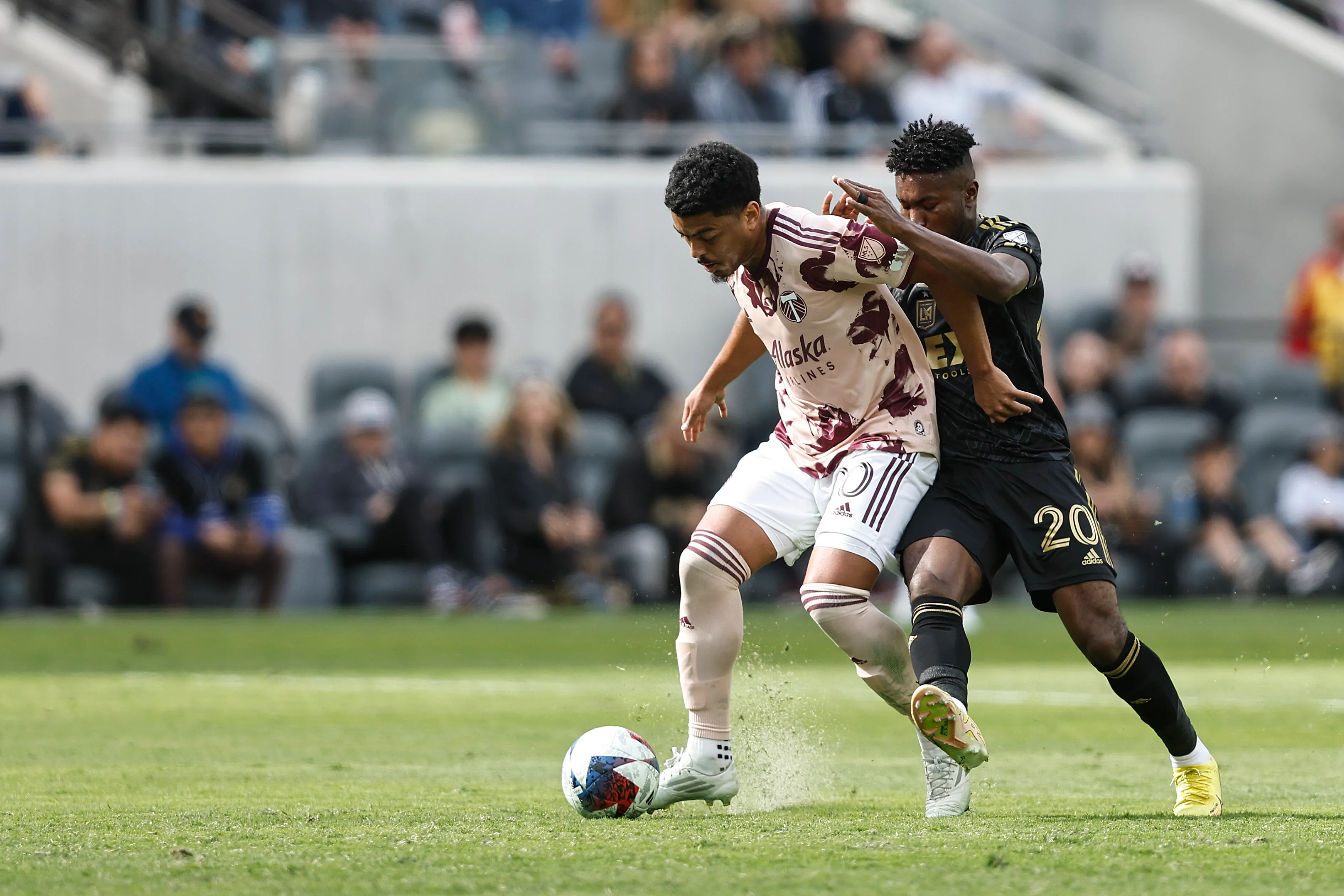 LOS ANGELES, CALIFORNIA – MARCH 04: Evander da Silva Ferreira of the Portland Timbers battles for the ball against José Cifuentes #20 of the Los Angeles FC during a game between the Portland Timbers and the Los Angeles Football Club at BMO Stadium on March 04, 2023 in Los Angeles, California. (Photo by Michael Owens/Getty Images)