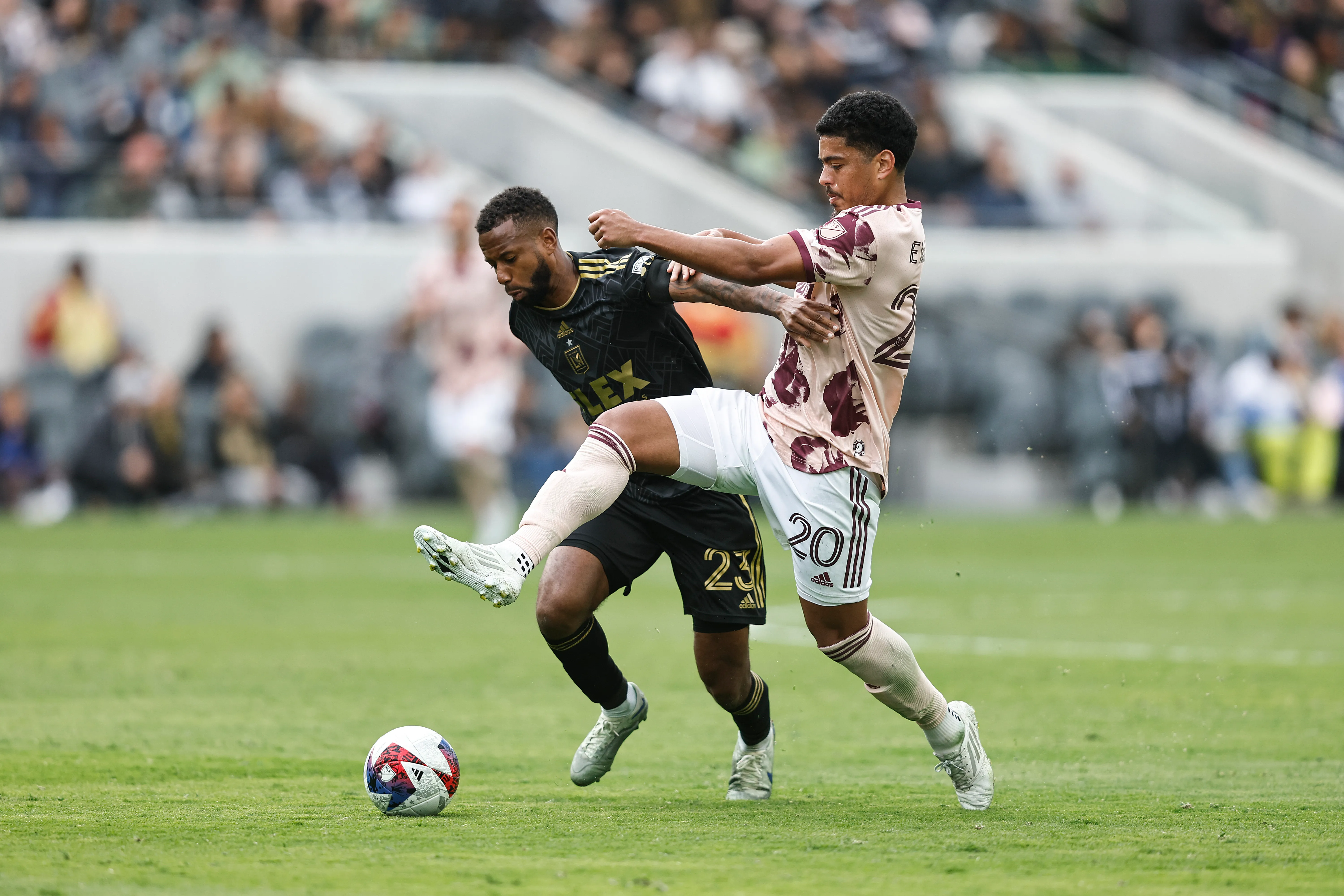 LOS ANGELES, CALIFORNIA – MARCH 04: Kellyn Acosta #23 of the Los Angeles FC and Evander da Silva Ferreira #20 of the Portland Timbers battle for the ball during a game between the Portland Timbers and the Los Angeles Football Club at BMO Stadium on March 04, 2023 in Los Angeles, California. (Photo by Michael Owens/Getty Images)