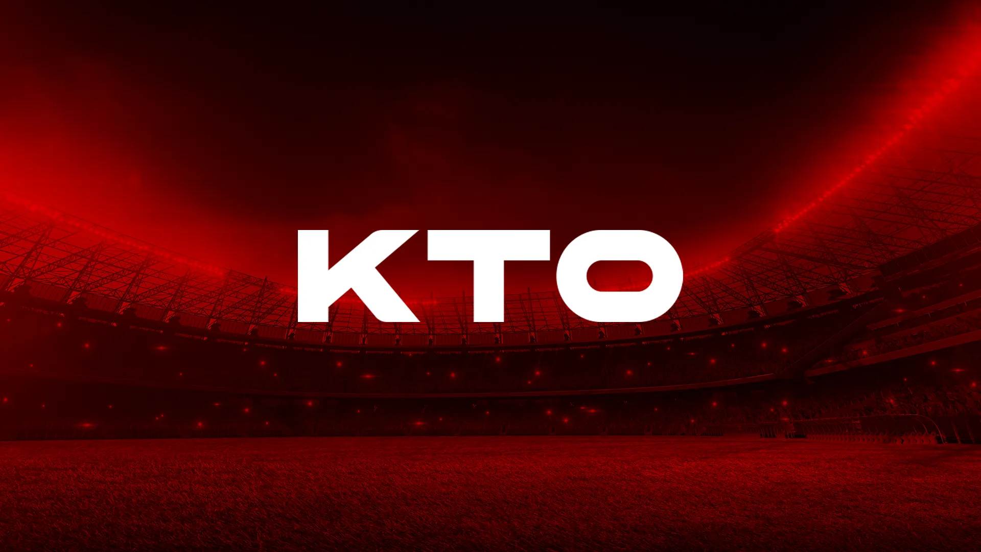 A imagem é um banner para a KTO. Diz KTO no meio em letras brancas e negrito. O fundo é vermelho e mostra uma imagem de um estádio tirada do campo. O estádio está cheio de pessoas, está iluminado, e é noite.