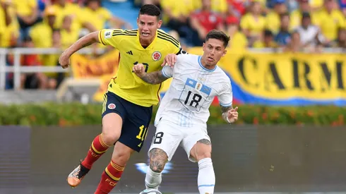 James Rodriguez of Colombia battles for possession with Brian Rodríguez of Uruguay during a FIFA World Cup 2026 Qualifier match between Colombia and Uruguay at Roberto Melendez Metropolitan Stadium on October 12, 2023 in Barranquilla, Colombia.