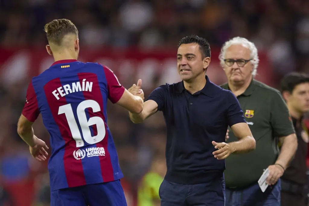 SEVILLE, SPAIN – MAY 26: Fermin Lopez of FC Barcelona celebrates after scoring the teams second goal with Xavi, Head Coach of FC Barcelona, during the LaLiga EA Sports match between Sevilla FC and FC Barcelona at Estadio Ramon Sanchez Pizjuan on May 26, 2024 in Seville, Spain. (Photo by Fran Santiago/Getty Images)