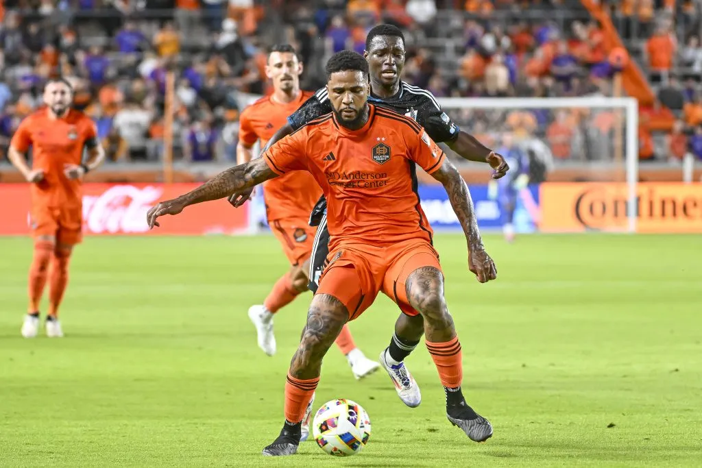 HOUSTON, TEXAS – JULY 13: Micael #31 of Houston Dynamo plays the ball from Bongokuhle Hlongwane #21 of Minnesota United in the first hafl  at Shell Energy Stadium on July 13, 2024 in Houston, Texas. (Photo by Logan Riely/Getty Images)