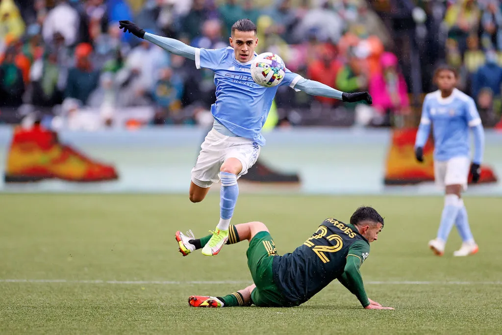 PORTLAND, OREGON – DECEMBER 11: Jesus Medina #19 of New York City jumps over Cristhian Paredes #22 of Portland Timbers while dribbling downfield during the second half of the 2021 MLS Cup final at Providence Park on December 11, 2021 in Portland, Oregon. (Photo by Steph Chambers/Getty Images)