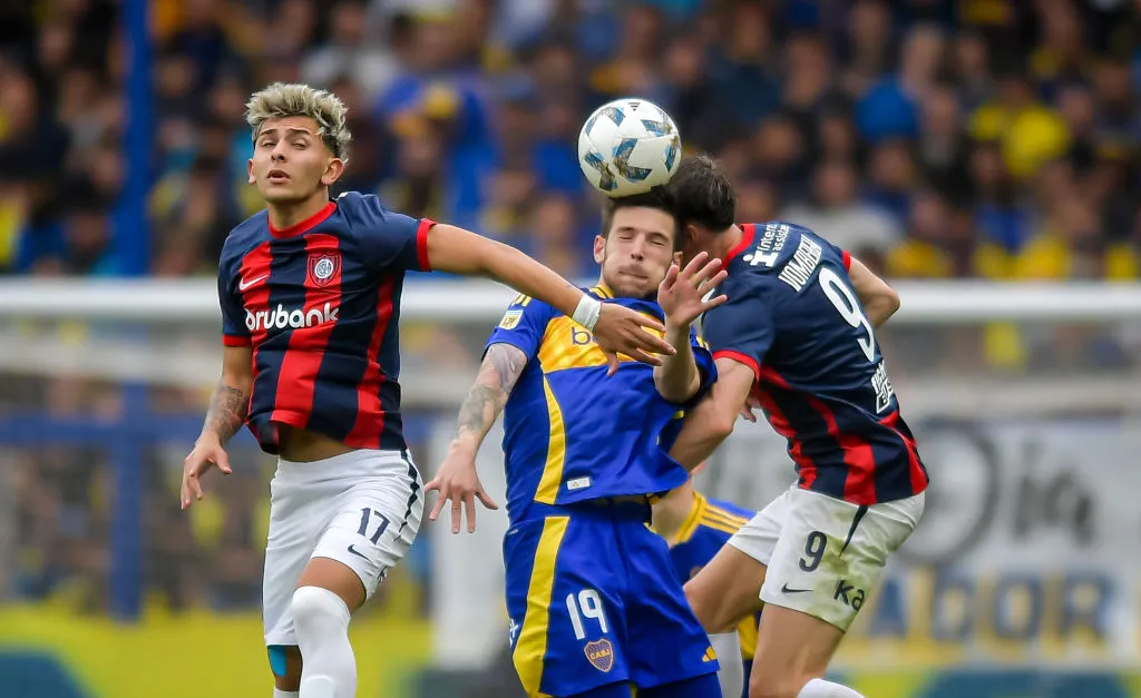 BUENOS AIRES, ARGENTINA – AUGUST 18: Agustin Martegani of Boca Juniors competes for the ball against Elian Irala and Andres Vombergar of San Lorenzo during a Liga Profesional 2024 match between Boca Juniors and San Lorenzo at Estadio Alberto J. Armando on August 18, 2024 in Buenos Aires, Argentina. (Photo by Marcelo Endelli/Getty Images)