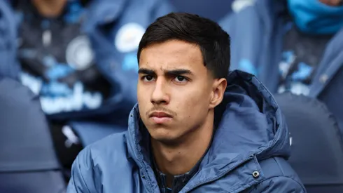 MANCHESTER, ENGLAND - MARCH 15: Vitor Reis of Manchester City looks on from the substitutes bench during the Premier League match between Manchester City FC and Brighton & Hove Albion FC at Etihad Stadium on March 15, 2025 in Manchester, England. (Photo by Matt McNulty/Getty Images)