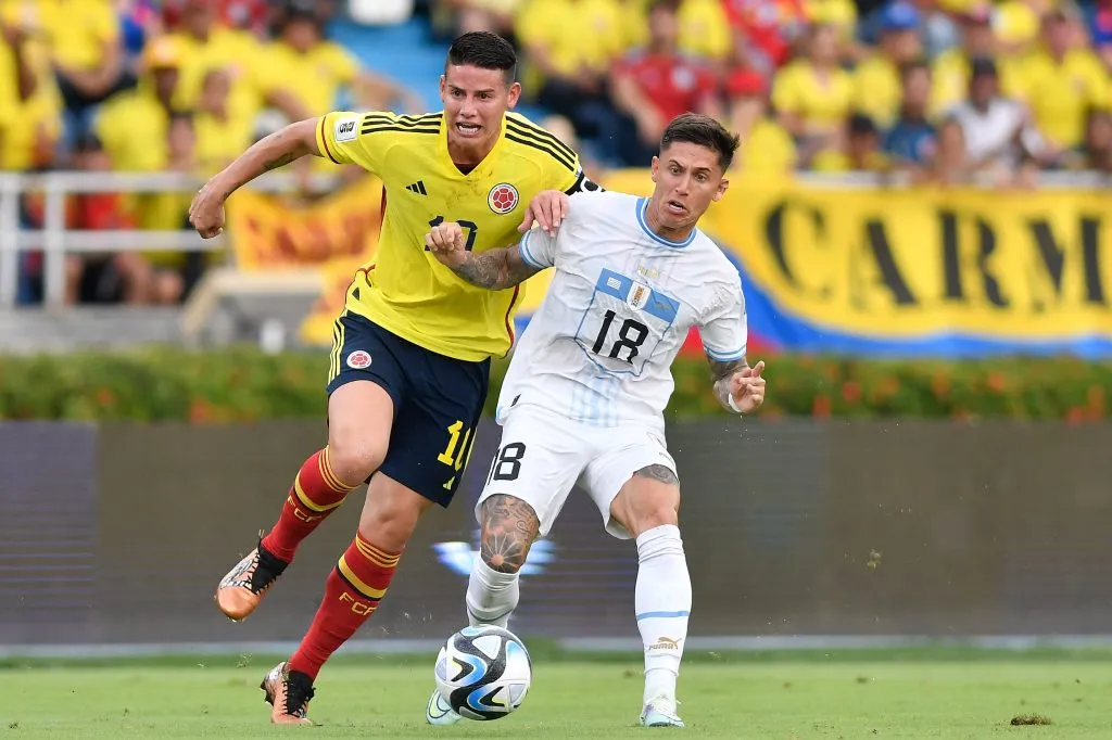 BARRANQUILLA, COLOMBIA – OCTOBER 12: James Rodriguez of Colombia battles for possession with Brian Rodríguez of Uruguay during a FIFA World Cup 2026 Qualifier match between Colombia and Uruguay at Roberto Melendez Metropolitan Stadium on October 12, 2023 in Barranquilla, Colombia. (Photo by Gabriel Aponte/Getty Images)