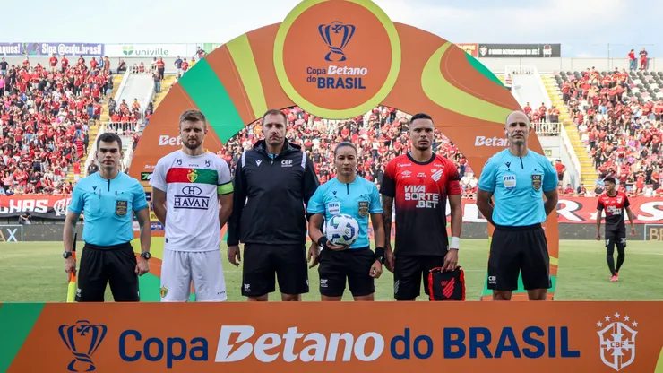Jogadores do Brusque e Athletico-PR posam para fotos ao lado do arbitro antes na partida no estadio Arena Joinville pelo campeonato Copa Do Brasil 2025. Foto: Lucas Gabriel Cardoso/AGIF