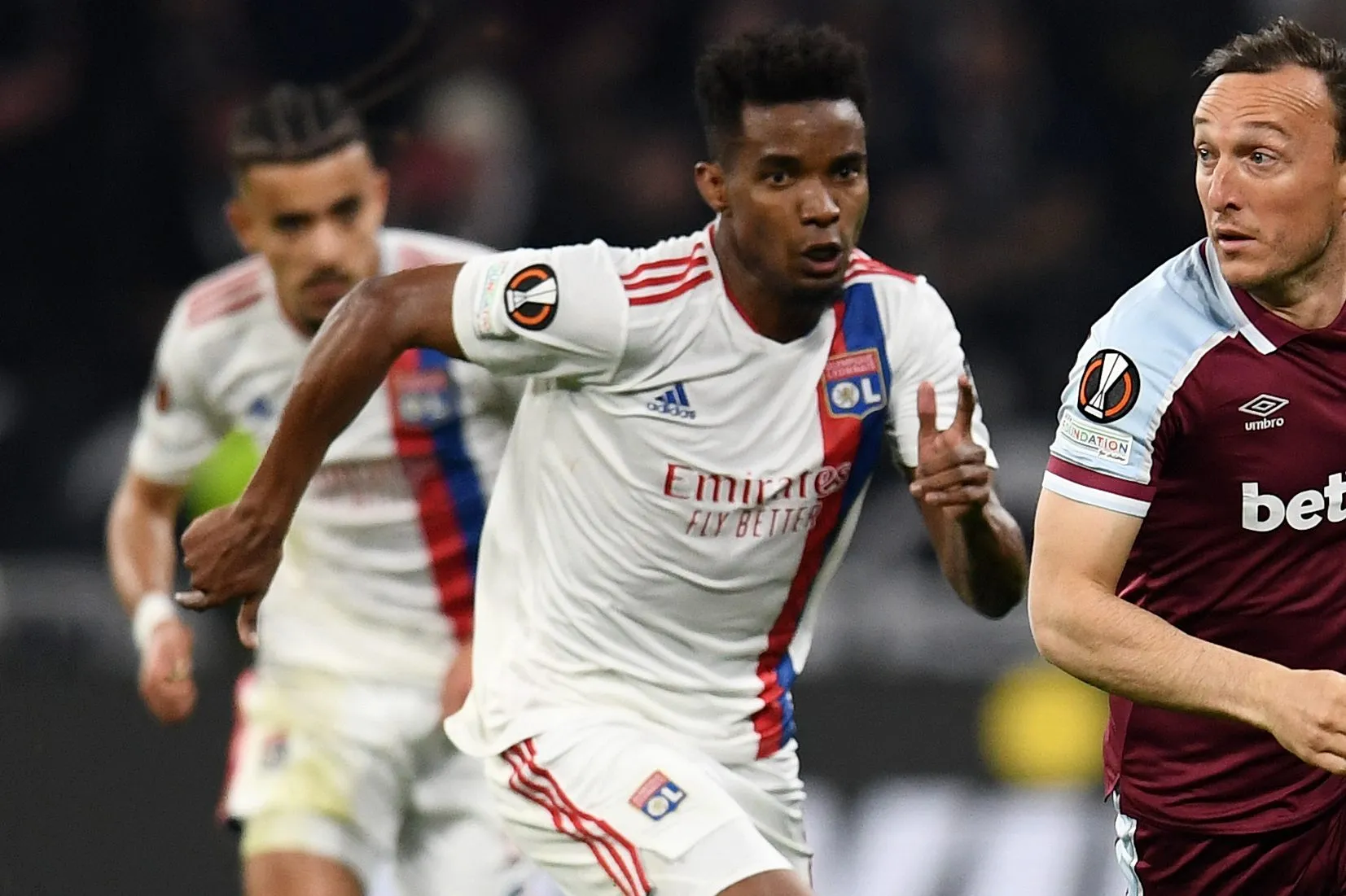 LYON, FRANCE – APRIL 14: Mark Noble of West Ham United runs ahead of Thiago Mendes of Olympique Lyonnais during the UEFA Europa League Quarter Final Leg Two match between Olympique Lyon and West Ham United at Parc Olympique on April 14, 2022 in Lyon, France. (Photo by Claudio Villa/Getty Images)