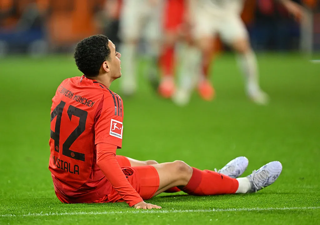 AUGSBURG, GERMANY – APRIL 04: Jamal Musiala of Bayern Munich goes down with an injury during the Bundesliga match between FC Augsburg and FC Bayern München at WWK-Arena on April 04, 2025 in Augsburg, Germany. (Photo by Sebastian Widmann/Getty Images)