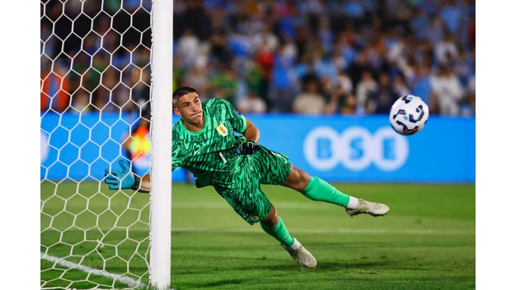 MONTEVIDEO, URUGUAY - NOVEMBER 15: Sergio Rochet of Uruguay fails to save Colombia's first goal scored by a free kick from Juan Fernando Quintero of Colombia (not in frame) during the South American Qualifier match between Uruguay and Colombia at Centenario Stadium on November 15, 2024 in Montevideo, Uruguay. (Photo by Ernesto Ryan/Getty Images)