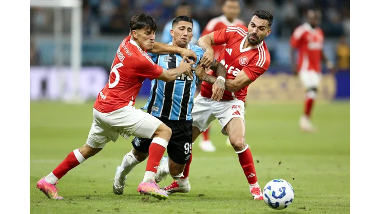 PORTO ALEGRE, BRAZIL - APRIL 19: Cristian Olivera of Gremio and Bruno Henrique and Alexandro Bernabei of Internacional compete for the ball during the match between Gremio and Internacional as part of Brasileirao 2025 at Arena do Gremio on April 19, 2025 in Porto Alegre, Brazil. (Photo by Pedro H. Tesch/Getty Images)