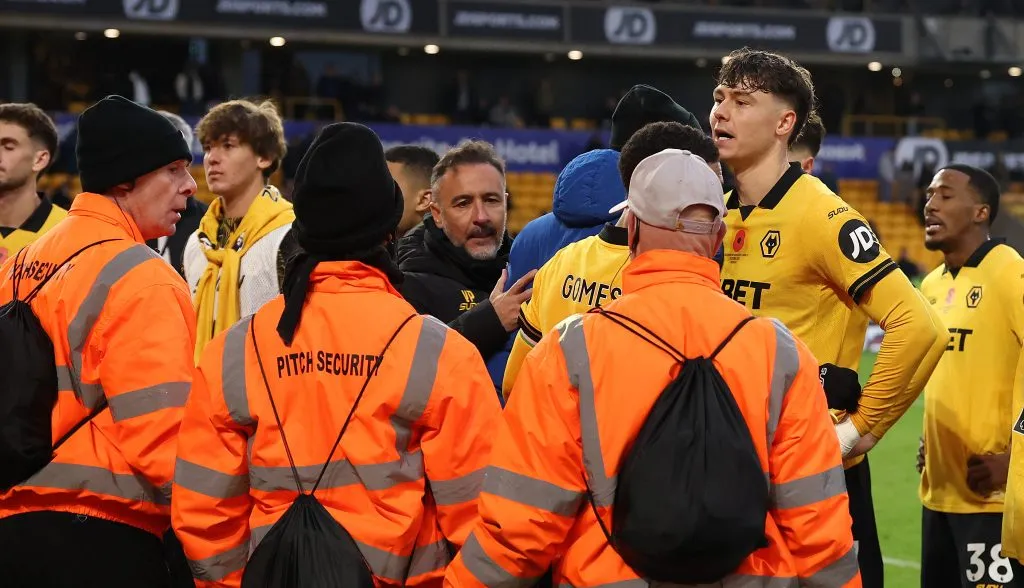 WOLVERHAMPTON, ENGLAND – OCTOBER 26:   Vitor Pereira, the Wolverhampton Wanderers manager (C) and club captain, Jorgen Strand Larsen held after clashing with supporters after their defeat during the Premier League match between Wolverhampton Wanderers and Burnley at Molineux on October 26, 2025 in Wolverhampton, England. (Photo by David Rogers/Getty Images)