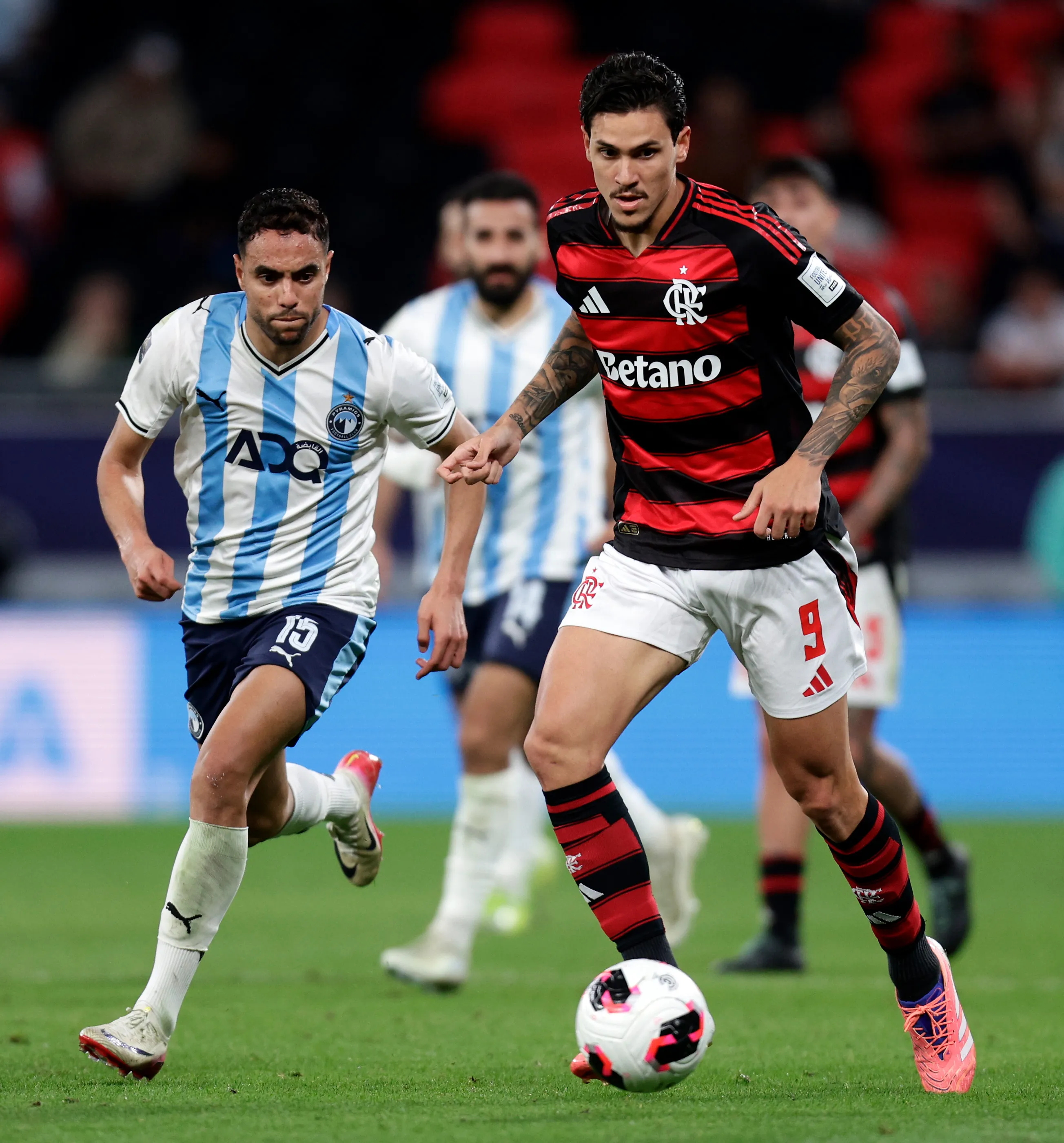 DOHA, QATAR – DECEMBER 13: Pedro of CR Flamengo runs with the ball whilst under pressure from Mohamed Chibi of Pyramids FC during the FIFA Challenger Cup 2025 match between CR Flamengo and Pyramids FC at Ahmad Bin Ali Stadium on December 13, 2025 in Doha, Qatar. (Photo by Getty Images/Getty Images)