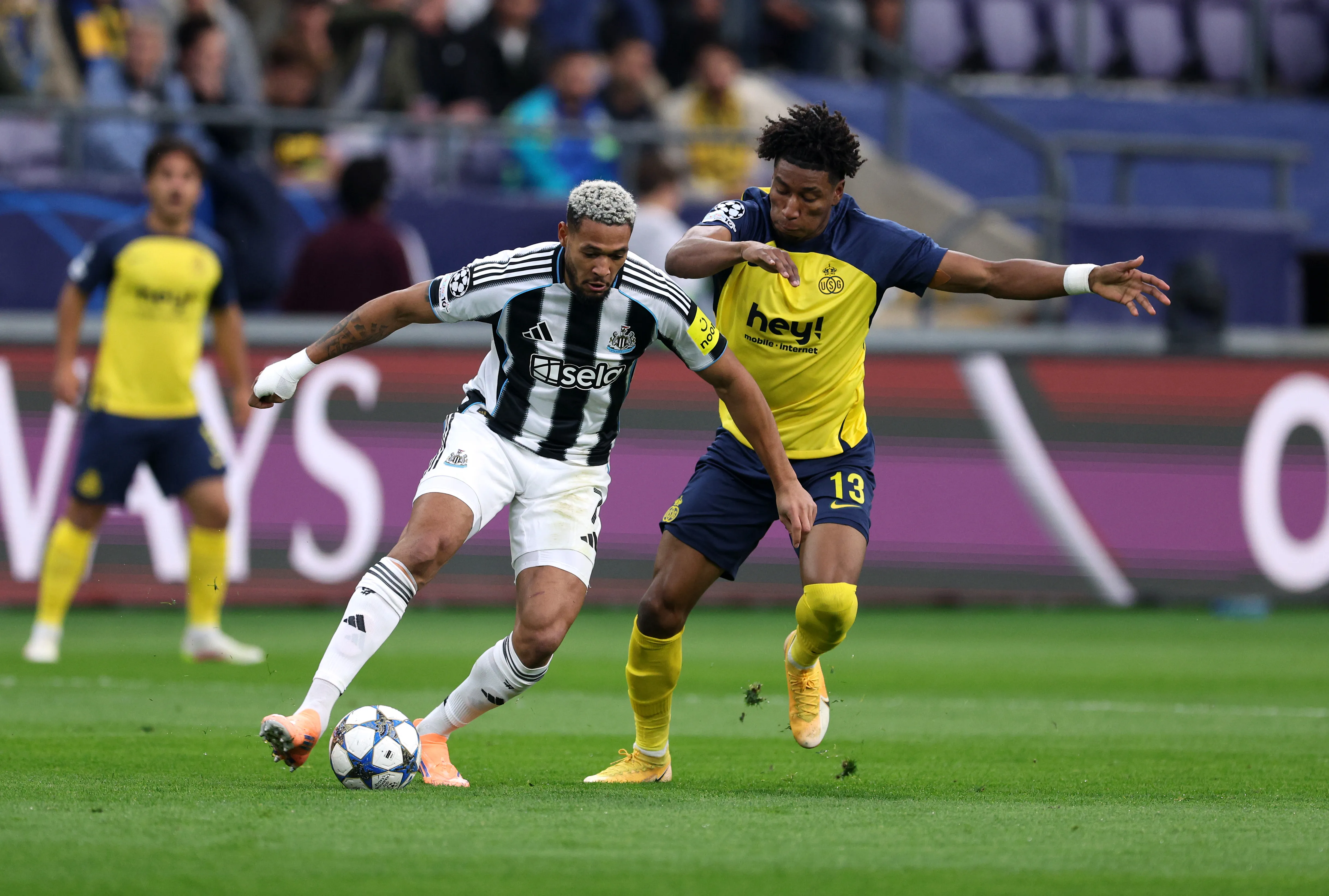 Kevin Rodríguez marcado por Joelinton em partida da Champions League. (Photo by Stuart Franklin/Getty Images)