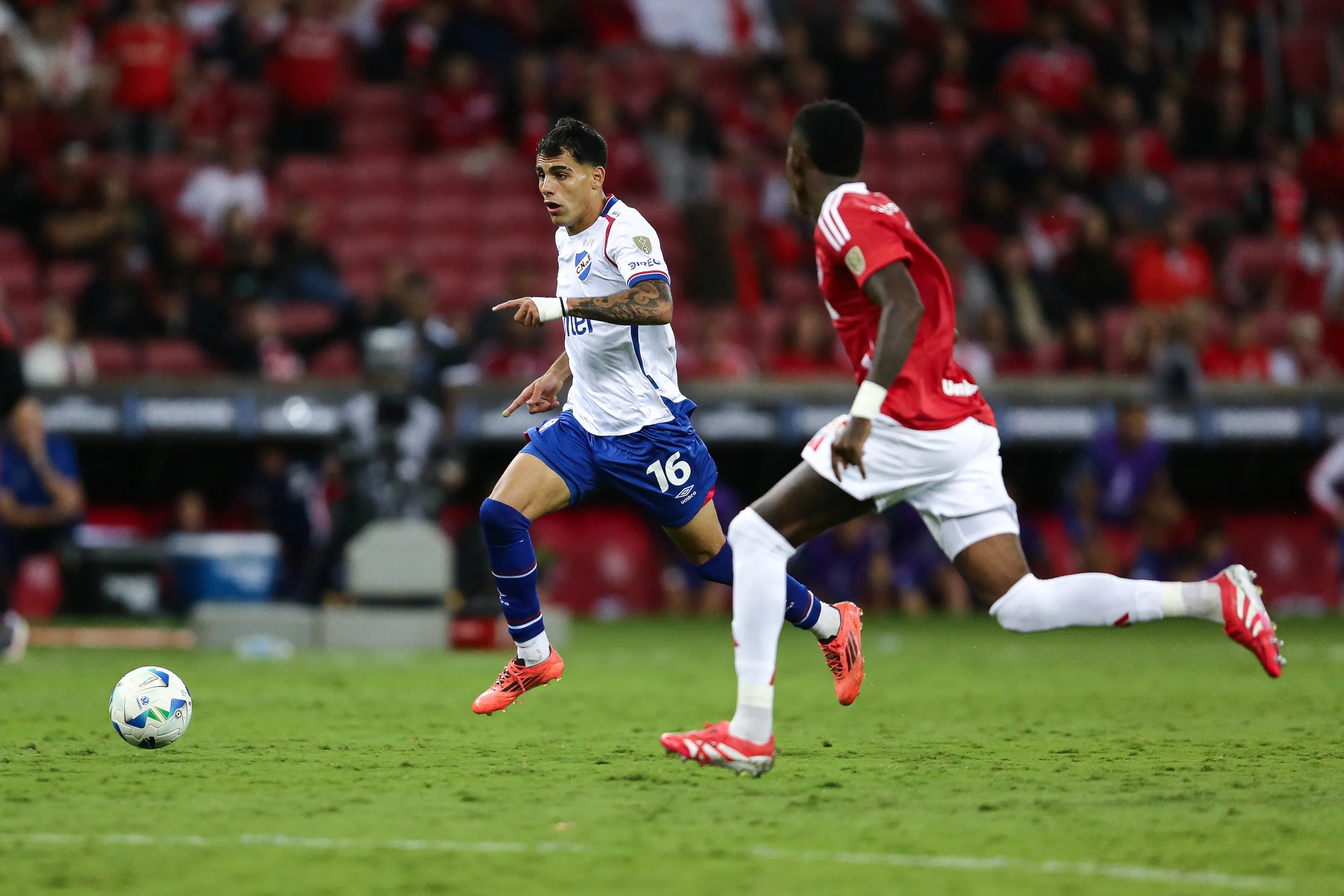 PORTO ALEGRE, BRAZIL – APRIL 22: Vitão of Internacional and Lucas Villalba of Nacional compete for the ball during the Copa CONMEBOL Libertadores Group F match between Internacional and Nacional at Beira-Rio Stadium on April 22, 2025 in Porto Alegre, Brazil. (Photo by Pedro H. Tesch/Getty Images)