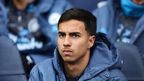 Vitor Reis of Manchester City looks on from the substitutes bench during the Premier League match between Manchester City FC and Brighton & Hove Albion FC at Etihad Stadium on March 15, 2025 in Manchester, England. (Photo by Matt McNulty/Getty Images)