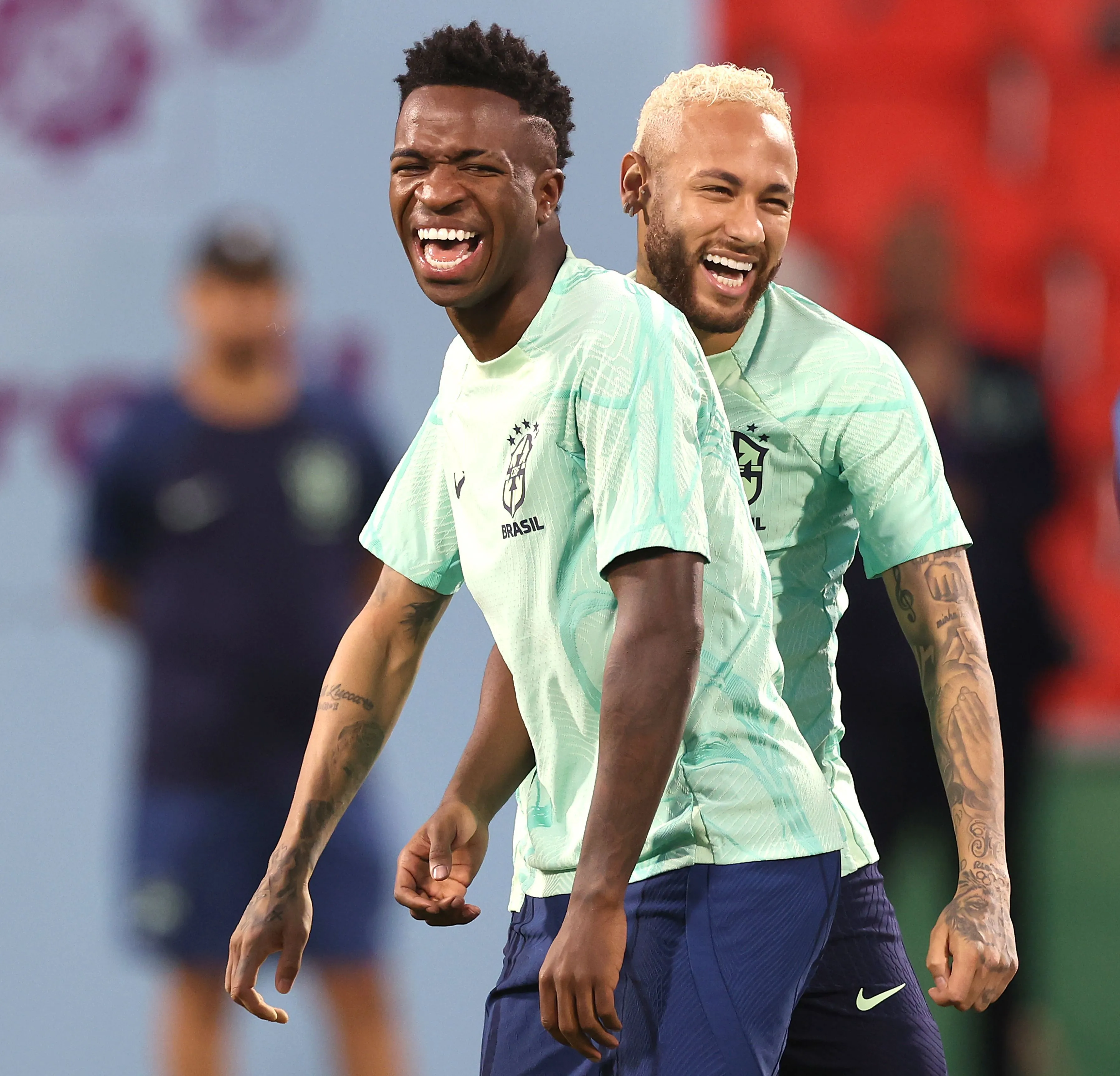DOHA, QATAR – DECEMBER 08: Neymar of Brazil jokes with team mate Vinicius Junior (L) during a training session on match day -1 at Al Arabi SC Stadium on December 08, 2022 in Doha, Qatar. (Photo by Alexander Hassenstein/Getty Images)