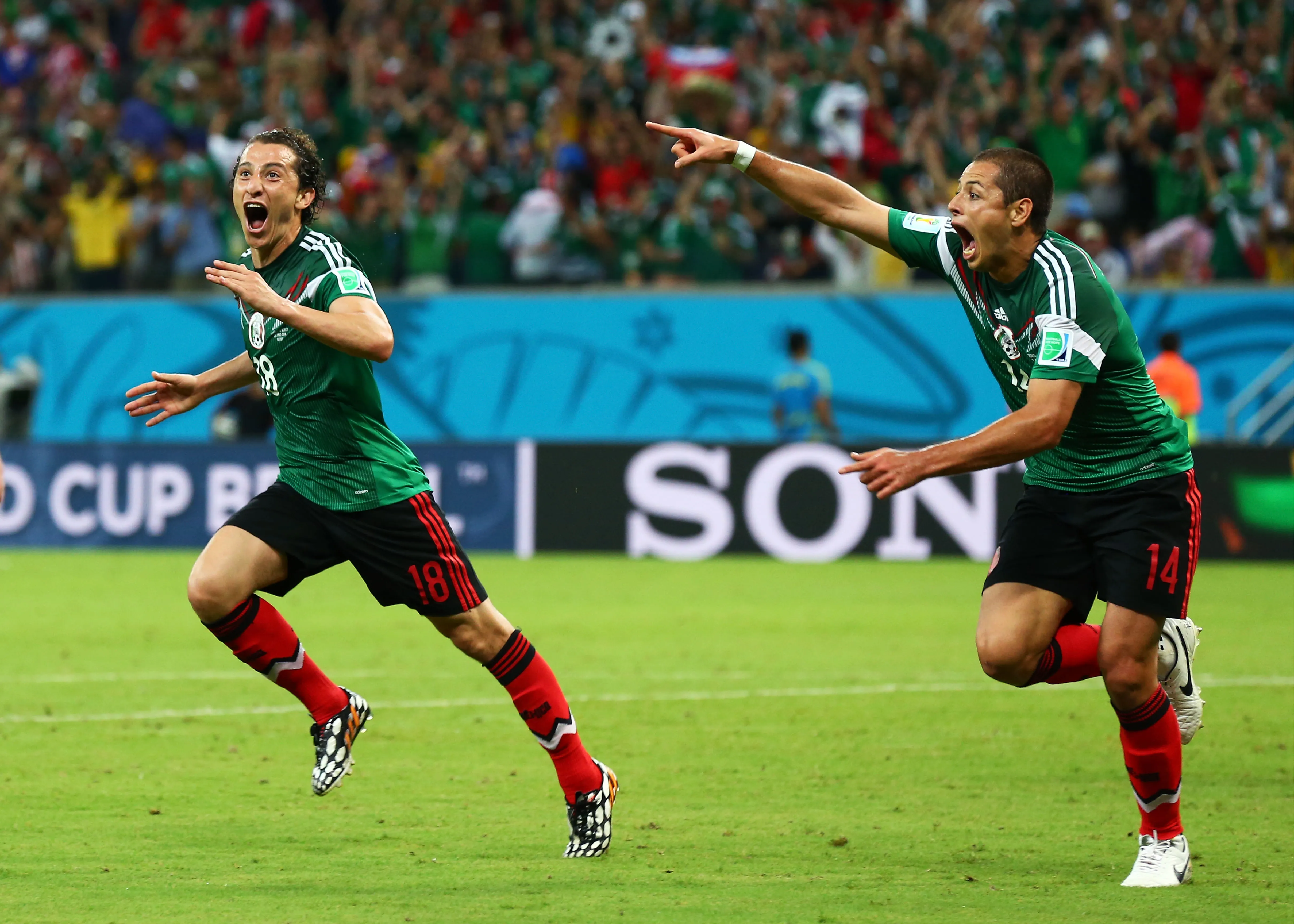 RECIFE, BRAZIL – JUNE 23:  Andres Guardado  (L)  and Javier Hernandez of Mexico celebrate their team’s second goal during the 2014 FIFA World Cup Brazil Group A match between Croatia and Mexico at Arena Pernambuco on June 23, 2014 in Recife, Brazil.  (Photo by Robert Cianflone/Getty Images)