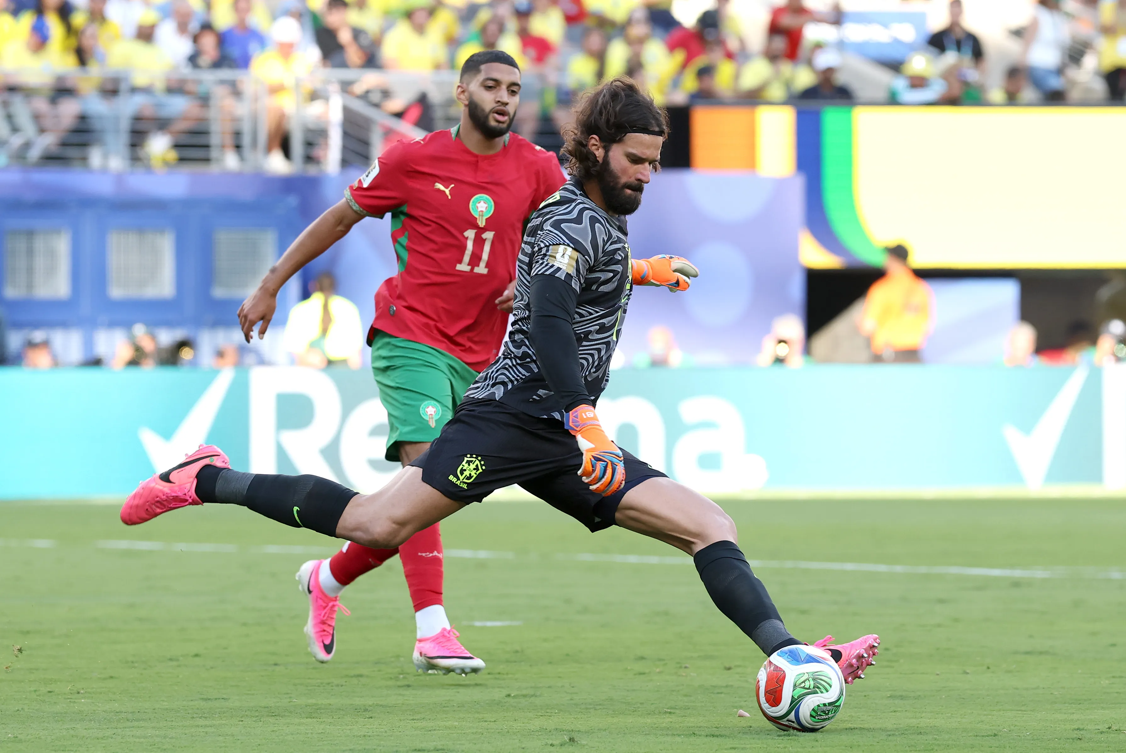 EAST RUTHERFORD, NEW JERSEY – JUNE 13: Alisson #1 of Brazil clears the ball under pressure from Ismael Saibari #11 of Morocco during the FIFA World Cup 2026 Group C match between Brazil and Morocco at New York New Jersey Stadium on June 13, 2026 in East Rutherford, New Jersey. (Photo by Darrian Traynor/Getty Images)