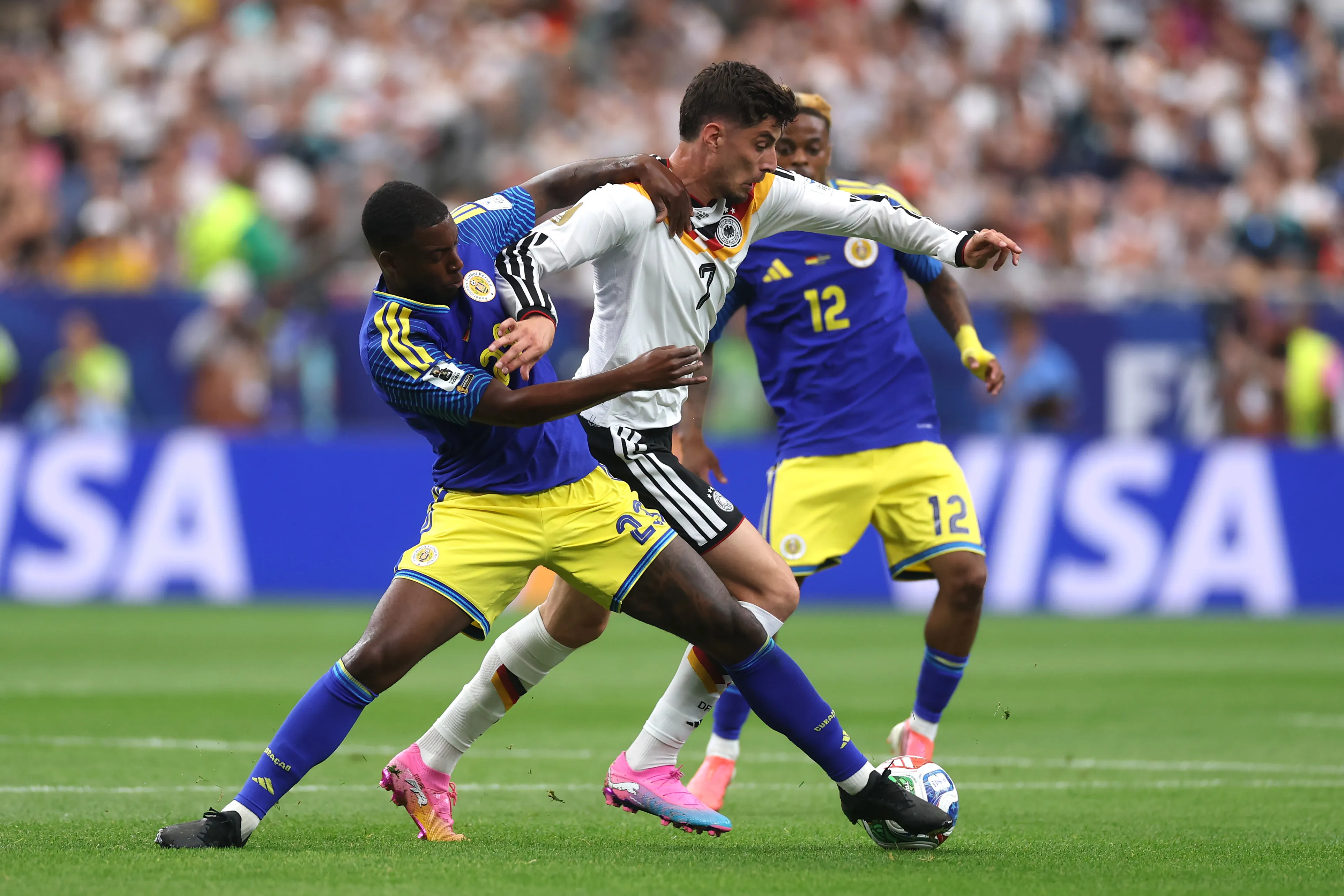 HOUSTON, TEXAS – JUNE 14: Kai Havertz #7 of Germany is challenged by Riechedly Bazoer #23 of Curacao during the FIFA World Cup 2026 Group E match between Germany and Curacao at Houston Stadium on June 14, 2026 in Houston, Texas. (Photo by Lars Baron/Getty Images)
