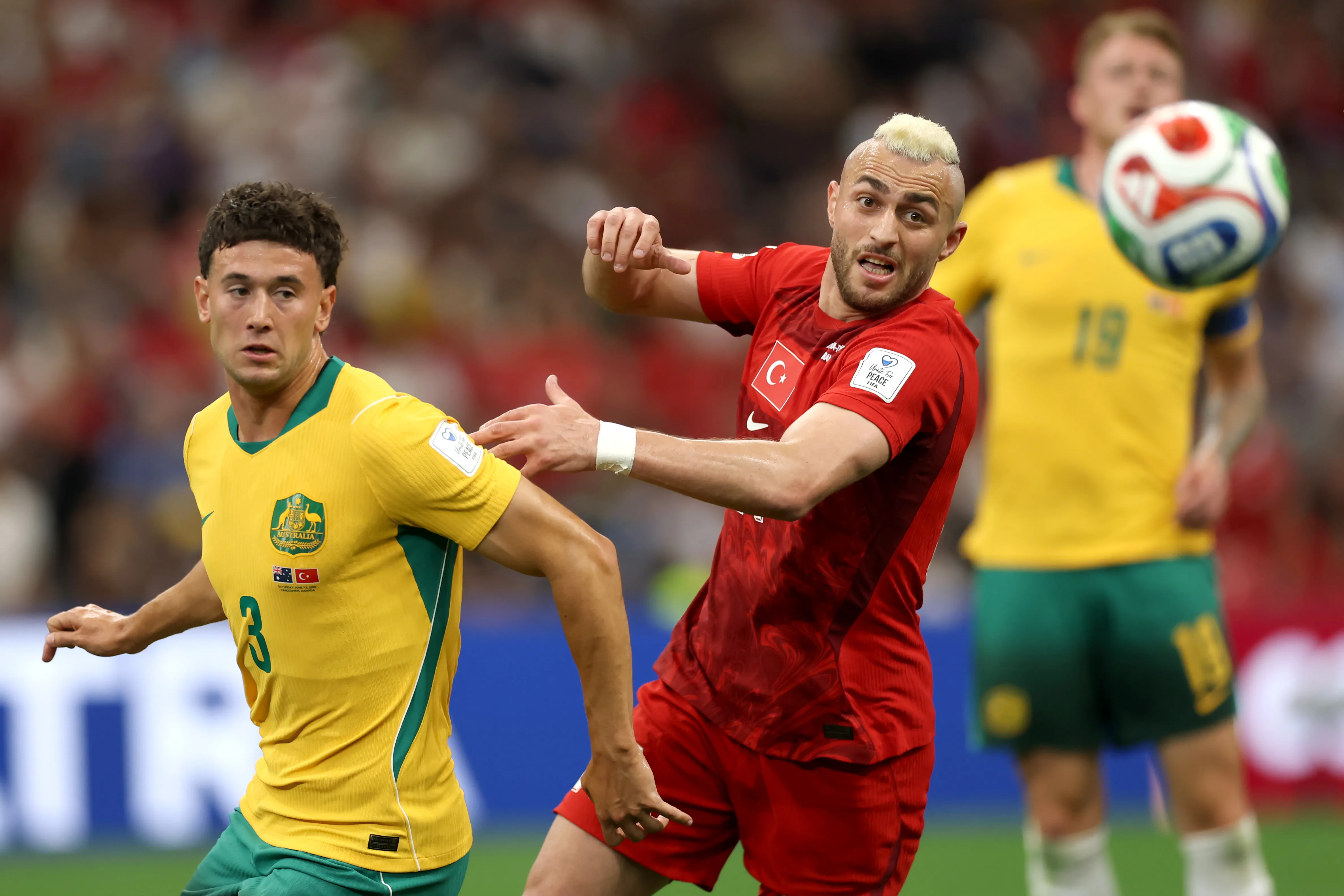 VANCOUVER, BRITISH COLUMBIA – JUNE 13: Baris Alper Yilmaz #21 of Turkiye and Alessandro Circati #3 of Australia compete for the ball during the FIFA World Cup 2026 Group D match between Australia and Türkiye at BC Place Vancouver on June 13, 2026 in Vancouver, British Columbia. (Photo by Dean Mouhtaropoulos/Getty Images)