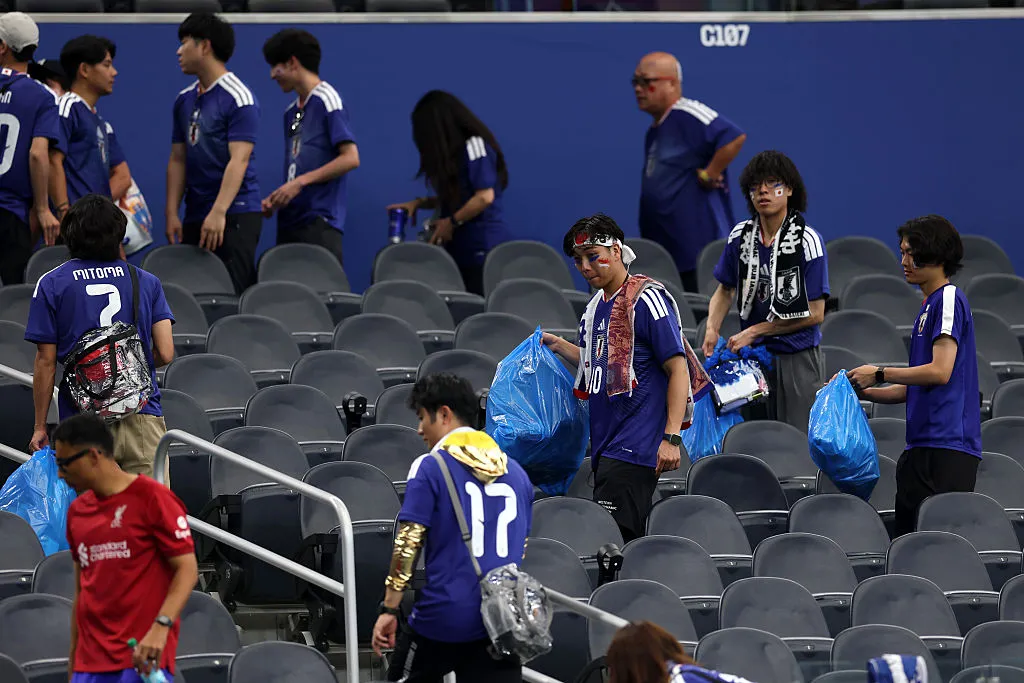 Japan fans clear trash in the stands during the FIFA World Cup 2026 Group F match between Netherlands and Japan at Dallas Stadium on June 14, 2026 in Arlington, Texas. (Photo by Michael Steele/Getty Images)