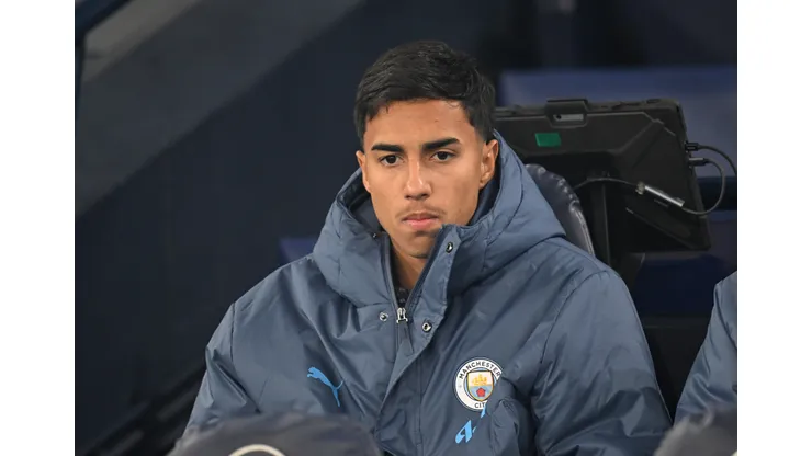 MANCHESTER, ENGLAND - JANUARY 25: Vitor Reis of Manchester City looks on from the substitutes bench prior to the Premier League match between Manchester City FC and Chelsea FC at Etihad Stadium on January 25, 2025 in Manchester, England. (Photo by Michael Regan/Getty Images)