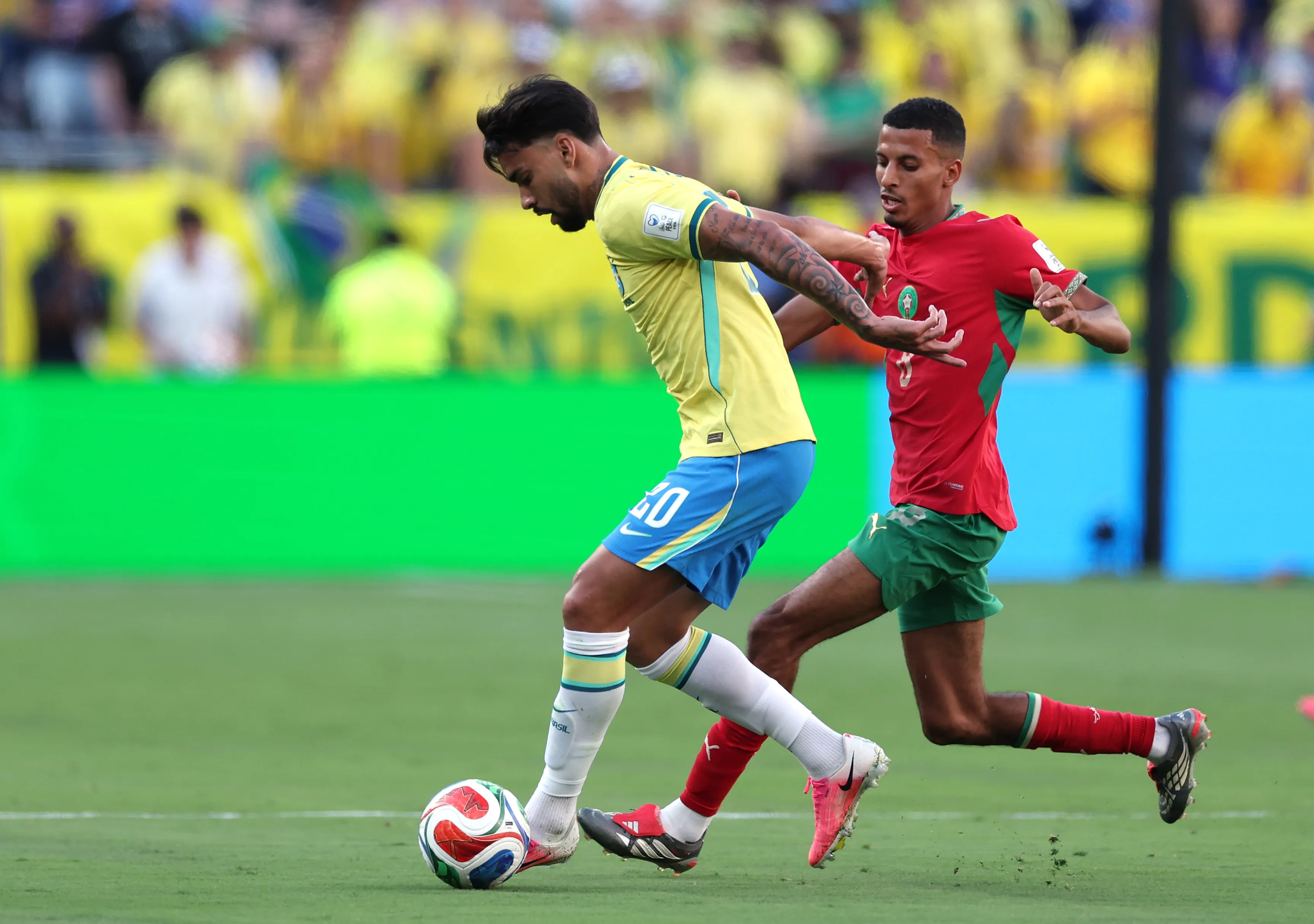 EAST RUTHERFORD, NEW JERSEY – JUNE 13: Lucas Paqueta #20 of Brazil is challenged by Azzedine Ounahi #8 of Morocco during the FIFA World Cup 2026 Group C match between Brazil and Morocco at New York New Jersey Stadium on June 13, 2026 in East Rutherford, New Jersey. (Photo by Kevin C. Cox/Getty Images)