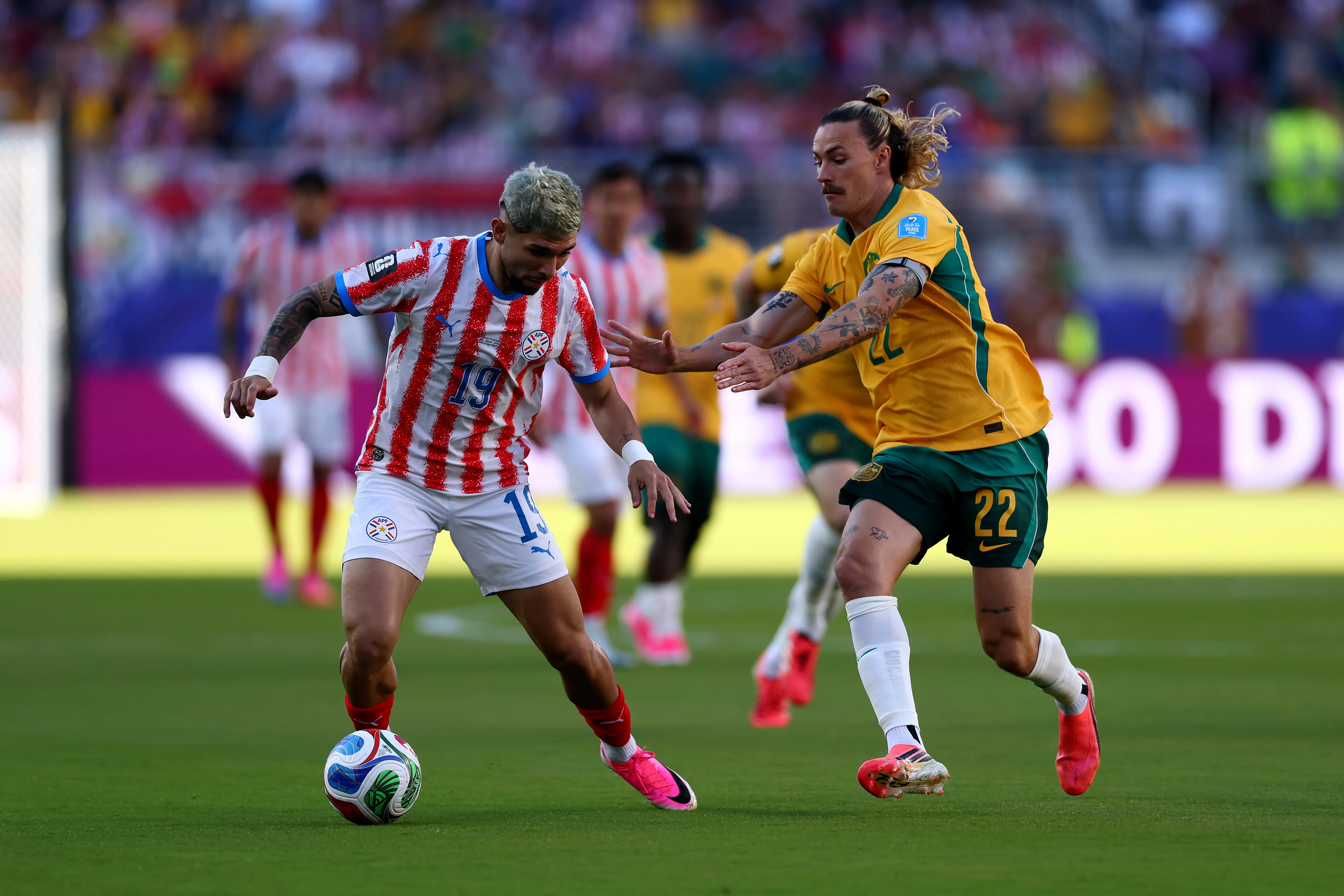 SANTA CLARA, CALIFORNIA – JUNE 25: Julio Enciso #19 of Paraguay controls the ball under pressure from Jackson Irvine #22 of Australia before the FIFA World Cup 2026 Group D match between Paraguay and Australia at San Francisco Bay Area Stadium on June 25, 2026 in Santa Clara, California. (Photo by Dean Mouhtaropoulos/Getty Images)