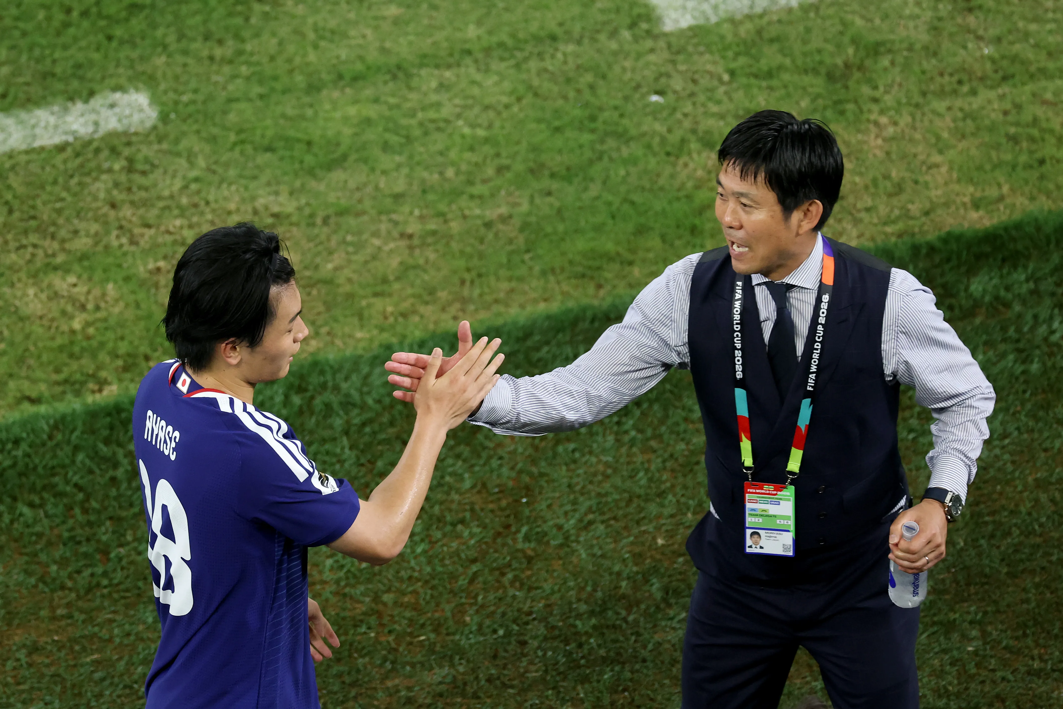 GUADALUPE, MEXICO – JUNE 20: Ayase Ueda #18 of Japan celebrates with Hajime Moriyasu, Head Coach of Japan, following a substitution after scoring the team’s fourth goal during the FIFA World Cup 2026 Group F match between Tunisia and Japan at Monterrey Stadium on June 20, 2026 in Guadalupe, Mexico. (Photo by Carl Recine/Getty Images)