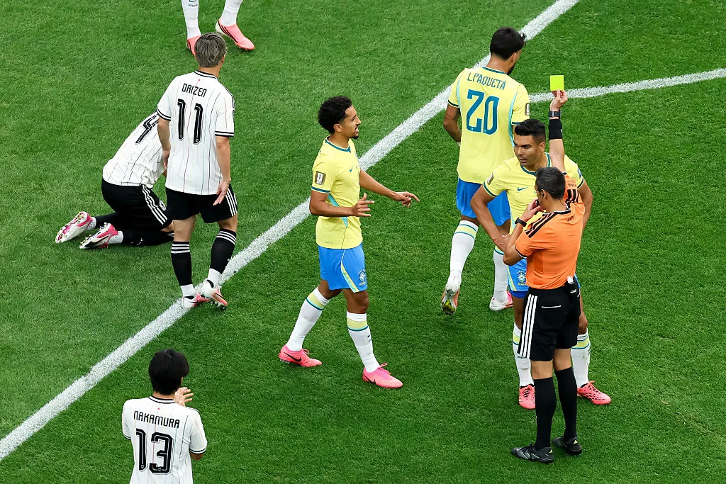 HOUSTON, TEXAS – JUNE 29: Referee Maurizio Mariani issues a yellow card to Casemiro #5 of Brazil after a foul on Junya Ito #14 of Japan during the FIFA World Cup 2026 Round Of 32 match between Brazil and Japan at Houston Stadium on June 29, 2026 in Houston, Texas. (Photo by Molly Darlington/Getty Images)