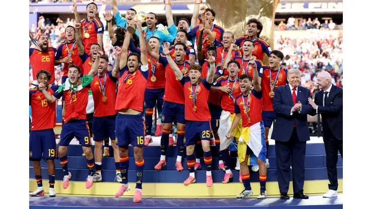 EAST RUTHERFORD, NEW JERSEY - JULY 19: Rodri #16 of Spain lifts the FIFA World Cup Winner’s Trophy alongside U.S. President Donald Trump and FIFA President Gianni Infantino after the team’s victory following during the FIFA World Cup 2026 Final match between Spain and Argentina at New York New Jersey Stadium on July 19, 2026 in East Rutherford, New Jersey. (Photo by Carl Recine/Getty Images)